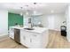 Modern open concept kitchen with stainless steel appliances, white cabinetry and large island at 511 Doctors Dr, Oviedo, FL 32765