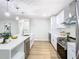 Bright kitchen featuring stainless steel appliances, white cabinetry, and modern pendant lighting at 511 Doctors Dr, Oviedo, FL 32765