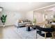 Bright living room featuring a neutral-toned sofa, stylish rug, and contemporary decor at 511 Doctors Dr, Oviedo, FL 32765