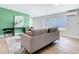 Cozy living room featuring a green accent wall, stylish decor, and comfortable seating at 511 Doctors Dr, Oviedo, FL 32765