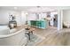 Spacious living room open to a modern kitchen, with wood floors and stylish decor at 511 Doctors Dr, Oviedo, FL 32765