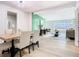 Open-concept living and dining area with stylish decor, light wood floors, and a green accent wall at 511 Doctors Dr, Oviedo, FL 32765