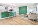 Bright living room with wood floors, a green accent wall, and modern furniture at 511 Doctors Dr, Oviedo, FL 32765