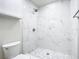 Bright shower with marble tile surround and decorative pebble floor at 511 Doctors Dr, Oviedo, FL 32765
