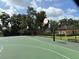 Outdoor basketball court featuring three hoops, benches, fencing, and a view of the community building at 516 Hickorywood Ave, Altamonte Springs, FL 32714