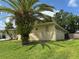 Exterior side view with mature palm trees and stone accents at 516 Hickorywood Ave, Altamonte Springs, FL 32714