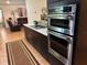 Gourmet kitchen showcasing stainless steel appliances and seamless flow to the living room, ideal for entertaining at 516 Hickorywood Ave, Altamonte Springs, FL 32714