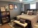Cozy main bedroom with comfortable bed, soft pillows, curated decor, and hardwood floors at 516 Hickorywood Ave, Altamonte Springs, FL 32714