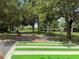 Community walking path with a crosswalk, mature trees, and lush landscaping for enjoying the outdoors at 516 Hickorywood Ave, Altamonte Springs, FL 32714