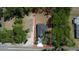Overhead view of home with large treed lot, defined by a red boundary and including a driveway and parking area at 544 E Voorhis Ave, Deland, FL 32724