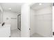 Bathroom and closet space with white walls, cabinets, and a view into the shower stall at 544 E Voorhis Ave, Deland, FL 32724