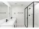 Bathroom with dual sinks, white cabinets, black hardware, and a luxurious walk-in shower with black trim at 544 E Voorhis Ave, Deland, FL 32724
