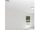 Brightly lit bedroom with neutral walls and flooring, featuring a window view at 544 E Voorhis Ave, Deland, FL 32724