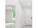 Bright entryway featuring white walls, gray wood-look flooring, and a view into another room at 544 E Voorhis Ave, Deland, FL 32724