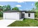 Charming single-story home with a two-car garage, fresh landscaping, and a well-manicured lawn at 544 E Voorhis Ave, Deland, FL 32724