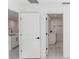 Hallway view towards the bathroom and open kitchen, creating a cohesive and accessible floor plan at 544 E Voorhis Ave, Deland, FL 32724