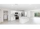 Spacious kitchen with white cabinetry, stainless steel appliances, a center island, and view to the outside patio at 544 E Voorhis Ave, Deland, FL 32724