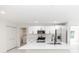 An open kitchen featuring white cabinets, stainless steel appliances and fixtures, with a central island at 544 E Voorhis Ave, Deland, FL 32724