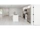 Open-concept kitchen with stainless steel appliances, white cabinets, a central island, and connecting rooms at 544 E Voorhis Ave, Deland, FL 32724