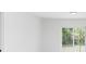Bright living room with a sliding glass door to the patio and a minimalist interior at 544 E Voorhis Ave, Deland, FL 32724