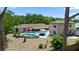 Expansive backyard featuring a pool, patio, and lush landscaping, creating a private outdoor oasis at 5496 S Nova Rd, Port Orange, FL 32127