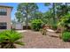 Spacious backyard featuring mature trees, privacy fence, storage shed, and a relaxing hammock at 5496 S Nova Rd, Port Orange, FL 32127