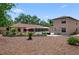 Expansive backyard featuring a pool, patio with outdoor seating, and a spacious mulched area, perfect for outdoor activities at 5496 S Nova Rd, Port Orange, FL 32127