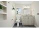 Bathroom with a modern vanity, toilet, and open shelving for storage and decor at 5496 S Nova Rd, Port Orange, FL 32127