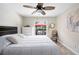 Well-lit bedroom with a ceiling fan and a window with a view of the pool and outdoor seating area at 5496 S Nova Rd, Port Orange, FL 32127