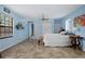 Bright bedroom features tile floors, a ceiling fan, and has access to the staircase at 5496 S Nova Rd, Port Orange, FL 32127