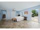 Bright bedroom features tile floors, a ceiling fan, and has an exterior door and sliding door access to the backyard at 5496 S Nova Rd, Port Orange, FL 32127