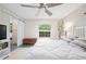 Bright bedroom with a ceiling fan, and a sliding barn door leading to the ensuite bathroom at 5496 S Nova Rd, Port Orange, FL 32127