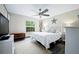 Comfortable bedroom featuring a ceiling fan, a window with backyard views, and neutral tones at 5496 S Nova Rd, Port Orange, FL 32127