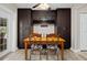 Dining area showcasing elegant built-in storage, wine rack, and backyard access at 5496 S Nova Rd, Port Orange, FL 32127