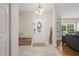 Bright and airy foyer with tile flooring, decorative front door, and views into the living area at 5496 S Nova Rd, Port Orange, FL 32127