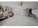 Spacious garage with epoxy flooring and ample storage space featuring installed shelving at 5496 S Nova Rd, Port Orange, FL 32127