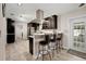 Open kitchen featuring stainless appliances, bar seating, and access to backyard at 5496 S Nova Rd, Port Orange, FL 32127