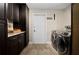 Laundry room with washer, dryer, built-in cabinets, and granite countertops for folding and storage at 5496 S Nova Rd, Port Orange, FL 32127