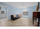 Cozy living room with tile floors, a comfortable futon, and natural light streaming through the window at 5496 S Nova Rd, Port Orange, FL 32127