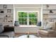 Bright living room features a window seat with nature views and custom built-in shelving at 5496 S Nova Rd, Port Orange, FL 32127