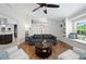 Inviting living room featuring hardwood floors, a comfortable sofa, and seamless flow into the adjacent kitchen at 5496 S Nova Rd, Port Orange, FL 32127