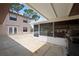 View of the patio featuring a screened in lanai with a grill and a view of the second story of the home at 5496 S Nova Rd, Port Orange, FL 32127