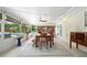 Relaxing sunroom with dining table, a ceiling fan, and views of the backyard pool at 5496 S Nova Rd, Port Orange, FL 32127