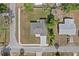 Aerial view of a single-Gathering home featuring a well-maintained lawn and mature trees at 560 Sumner Ave, Orange City, FL 32763