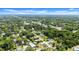 A high-angle shot of a neighborhood filled with trees and various residential houses at 560 Sumner Ave, Orange City, FL 32763