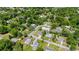 An aerial view of the home with lush green trees surrounding it and other neighborhood homes nearby at 560 Sumner Ave, Orange City, FL 32763