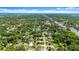 Aerial view of the neighborhood with trees and houses, showing the layout of the area at 560 Sumner Ave, Orange City, FL 32763