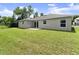 View of the home's spacious backyard featuring well-maintained lawn at 560 Sumner Ave, Orange City, FL 32763