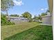 Backyard featuring a spacious lawn and the side facade of the house at 560 Sumner Ave, Orange City, FL 32763