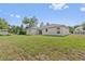 Backyard featuring a spacious lawn and the rear facade of the house at 560 Sumner Ave, Orange City, FL 32763